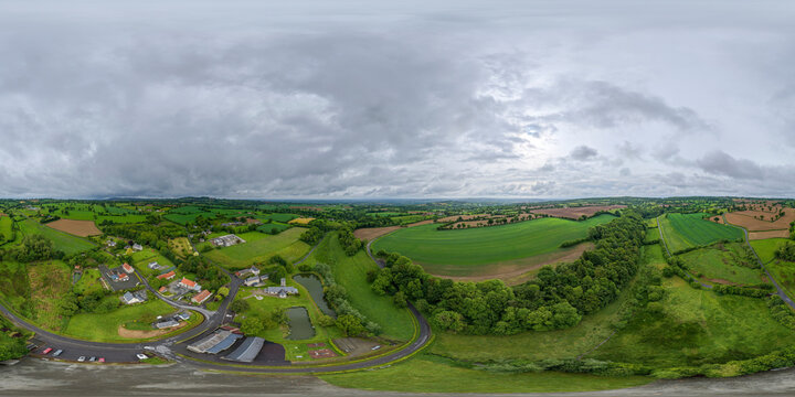 Rural Normandy landscape featuring green fields and small village