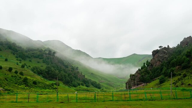 Misty Green Valley in Gannan, Gansu Province, China - Rolling Hills and Pastoral Fences