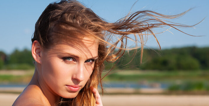 Young woman with windblown hair