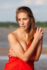 Nude woman wearing red fabric © misu