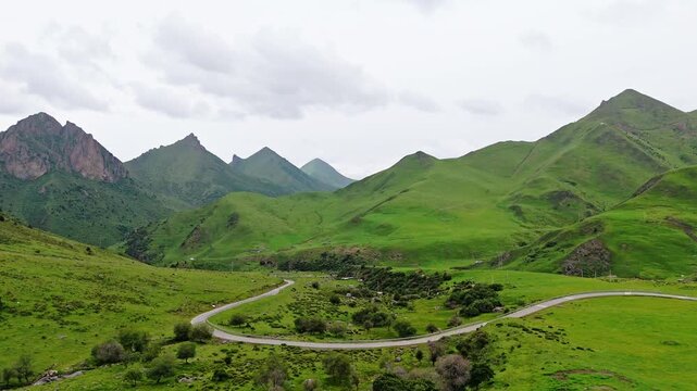 Aerial View of Winding Road Through Lush Green Mountains in Gannan, Gansu Province, China