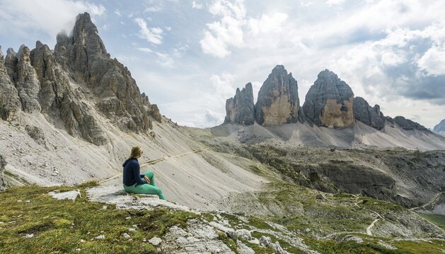 Hiker makes a break, Northern walls of the Three Peaks, Sesto Dolomites, South Tyrol, Trentino-South Tyrol, Alto-Adige, Italy