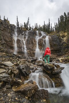 Hiker at a waterfall, Tangle Creek Falls, Jasper National Park, Alberta, Canada