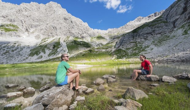 Hikers make a break, mountain lake at the Printz-Luitpolt House, Allg&auml;u Alps, Bad Hindelang, Allg&auml;u, Bavaria, Germany