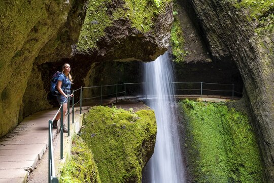 Hiker at Levada do Moinho, Waterfall in a gorge, Ponta do Sol, Madeira, Portugal