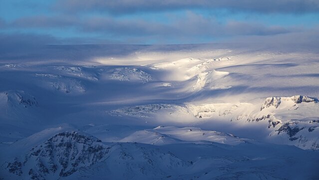 Light and shadow over the snowy hills and mountains of Myrdalsj&ouml;kull, Sudurland, Iceland