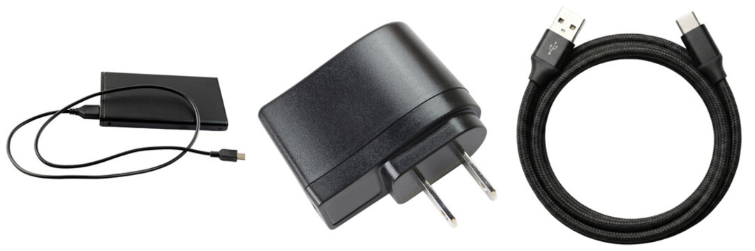 Black USB charger adapter, USB-C cable, and external hard drive isolated on white background