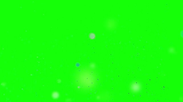 Vibrant green background with scattered white and yellow specks and particles floating around