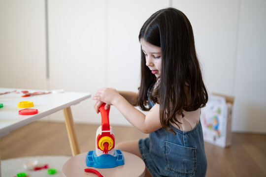 Child playing with clay at home