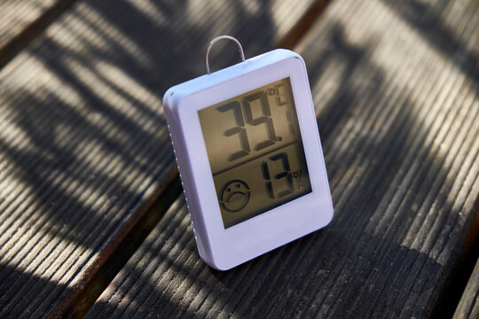 Digital thermometer on wooden bench