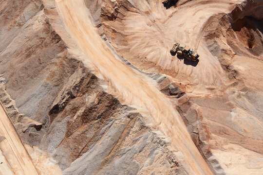 USA, Texas, aerial view of sand mine near San Antonio with a grader moving sand