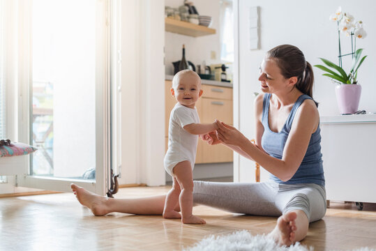 Portrait of happy baby girl with mother at home