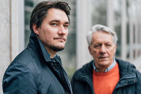 Portrait of young man and senior man in the city