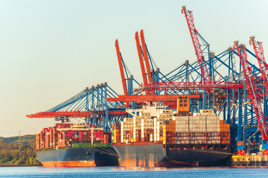 Container ship loading cargo at Hamburg harbor terminal