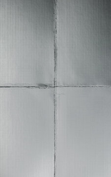 silver cardboard texture featuring visible folds, creases, wrinkles, and geometric panel sections.