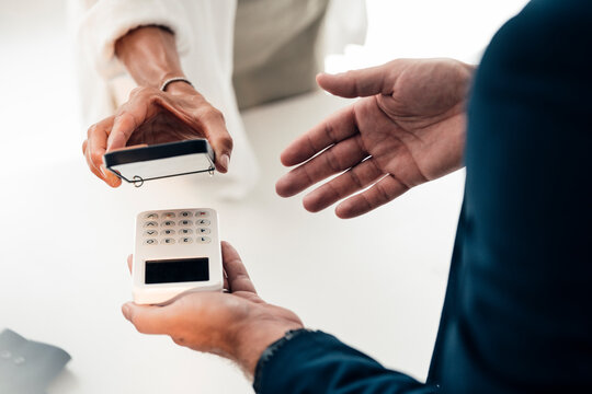Mature woman doing mobile payment through smart phone