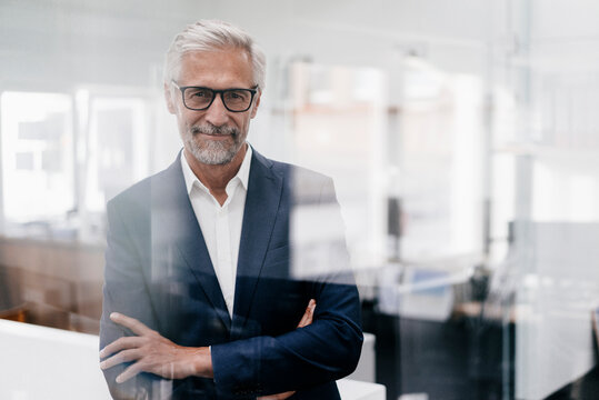 Portrait of confident mature businessman in office