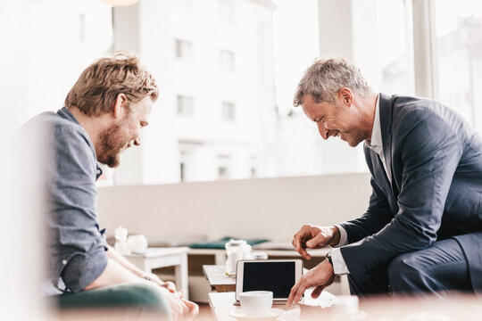 Businessman consulting customer in cafe