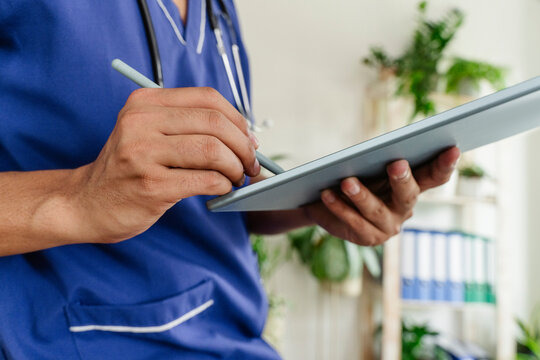 Doctor using tablet pc at healthcare clinic