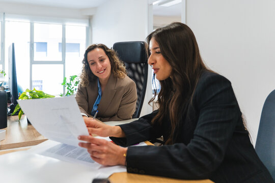 Businesswoman discussing paperwork during a meeting at the office