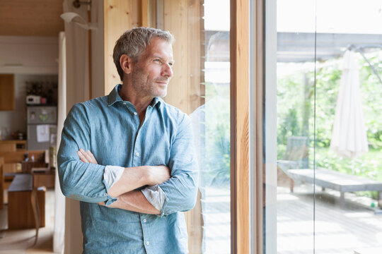 Mature man looking out of window