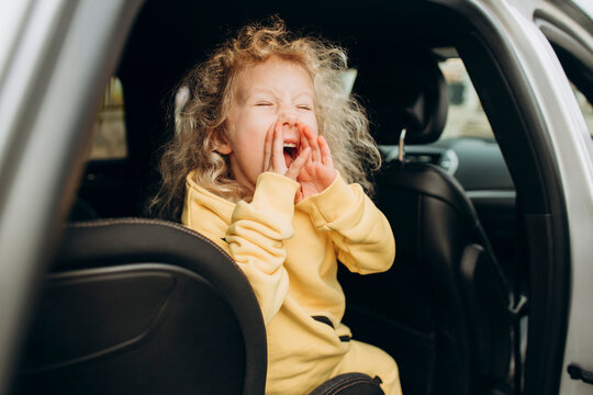 Playful girl screaming in car