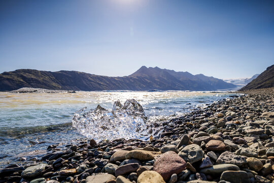 Ice fragment on rocky shore at Hoffellsj�kull Glacier Lagoon Iceland