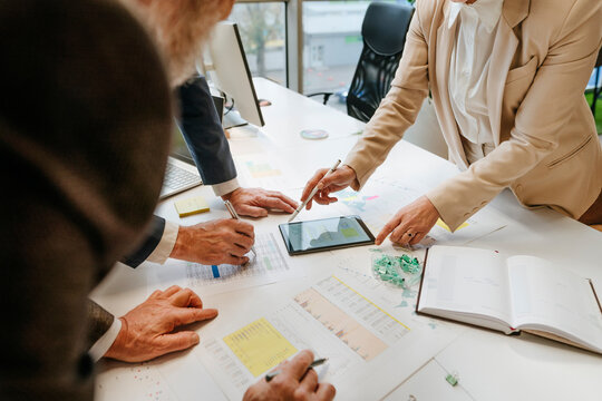 Business team discussing charts and data at office meeting