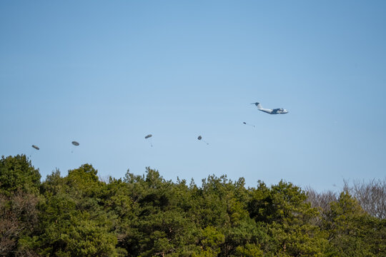 ZM401 RAF Royal Air Force Airbus C.1 A400M Atlas military cargo plane on a low-level cargo parachute drop exercise, blue sky light cloud