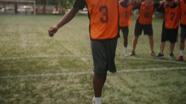 Football Player Scoring Goal and Celebrating with Team on the Field