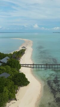 Aerial drone of tropical island and sandy beach. Timba Timba islet. Tun Sakaran Marine Park. Borneo, Sabah, Malaysia. Vertical video.