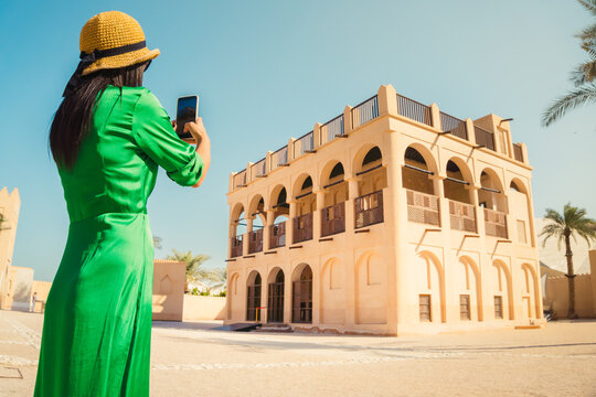 Doha, Qatar - 8th january, 2026: Tourist captures smartphone photo of historic Old Palace of Sheikh Abdullah bin Jassim Al Thani at the National Museum of Qatar. Classic desert architecture