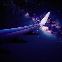 Fototapeta premium Airplane wing flies through starry night sky with Milky Way galaxy visible. Aircraft travels in deep space among stars and cosmic clouds. Journey to outer cosmos.
