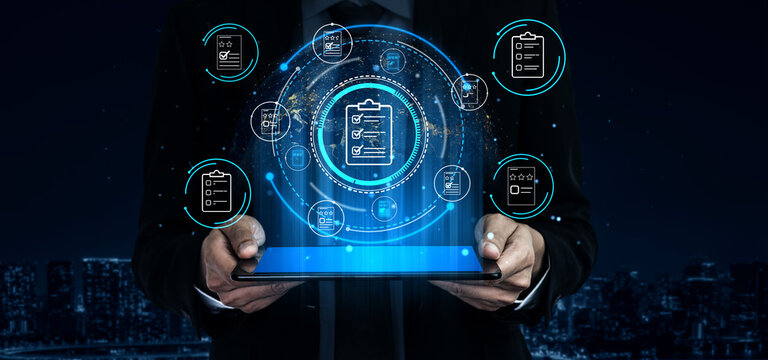 Businessman with modern digital tablet showcasing data analytics and project management graphics against a nighttime city skyline background. Entropy.