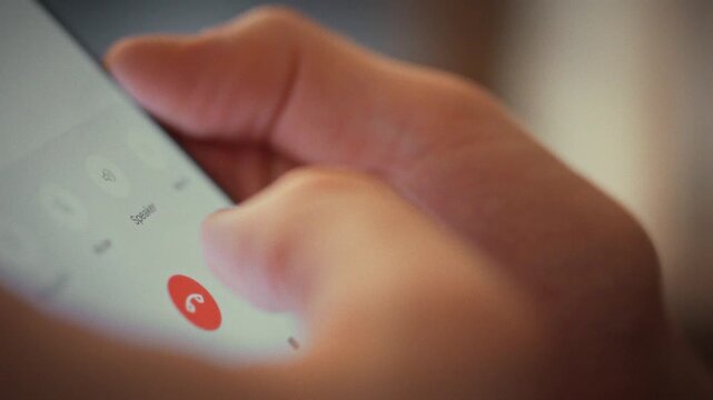 Man abruptly ends call by pressing red button, cutting off the conversation with his interlocutor. This simple gesture reflects how quickly people can terminate digital dialogues in everyday settings