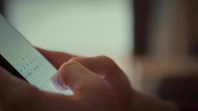 A man's fingers glide across a smartphone's touch keyboard, typing a note in a specialized app. This moment highlights mobile technology's power for instantly capturing ideas with speed and accuracy
