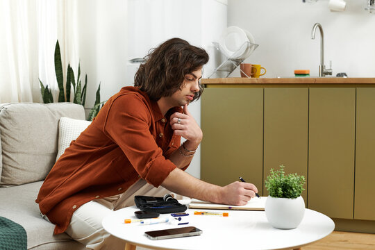 A young man with diabetes engages in daily activities at home, focusing on health and wellness.