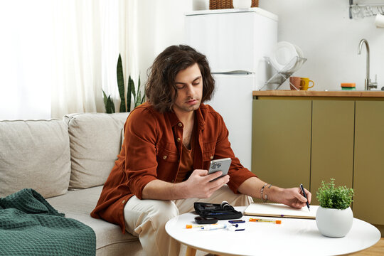 In a stylish apartment, a young man with diabetes engages in his daily routine, managing health.