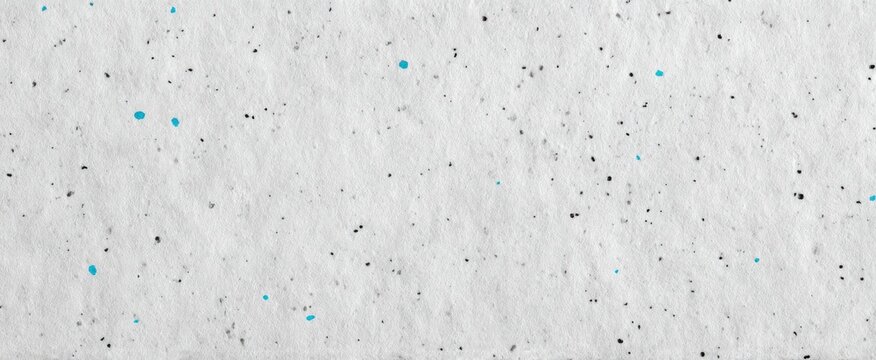 Soft gray paper sheet with blue and white speckles perfect for artistic projects.
