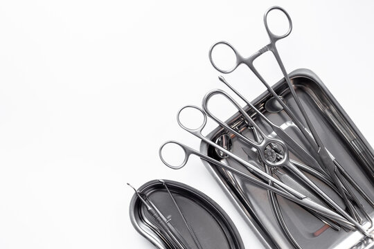 Sterile surgical instruments and tools - scalpels, scissors and others - in a stainless tray, top view