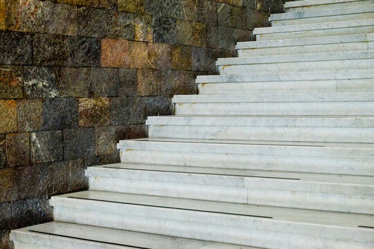 White Marble Staircase and Textured Stone Wall 