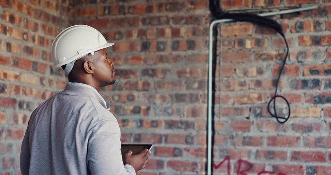 Picture, inspection and black man with tablet at construction site, compliance or infrastructure review. Back, evaluation and person with tech screen for wiring, installation or electrical line photo