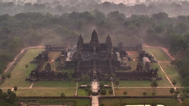 Aerial Drone view of the Majestic Angkor Wat temple complex in cambodia at Sunrise. UNESCO World Heritage Site.