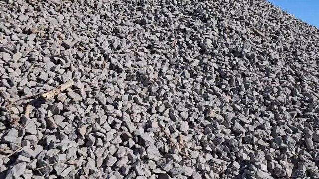 Rock landscape at a construction site showing various shapes and sizes in sunlight