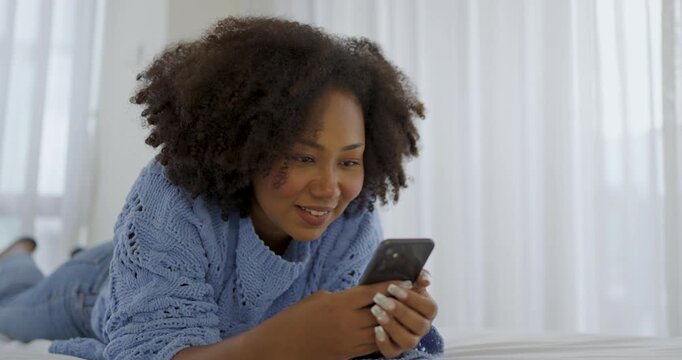 Black African woman with attractive smile use tablet smartphone on white bed, Portrait beauty girl relax in bedroom. Technology people connection digital online marketing e-commerce concept banner