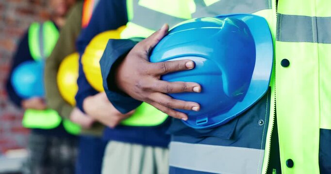 Building, hands and helmet with construction worker group on worksite for project management. Architecture, hard hat and safety with team of men in row at development site for civil engineering