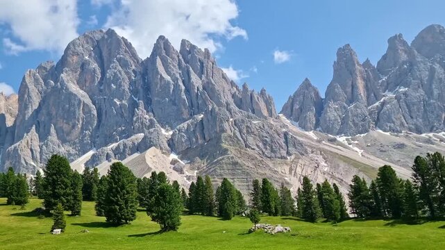 Amazing mountain landscape of the Puez-Odle Nature Park with the sharp peaks of Odle mountains and green meadows in Dolomites, Italy