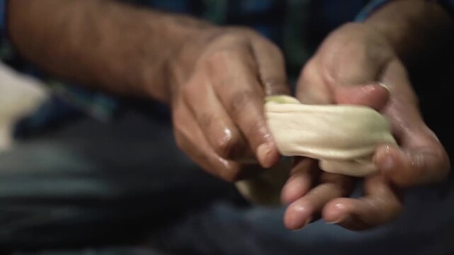 Close up shot of preparing dough for traditional laccha paratha in Indian kitchen.