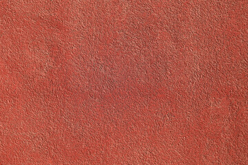 Fototapeta premium Textured background. Decorative plaster wall, external of facade. Texture of red pink peach fuzz stucco plaster wall of clay house structure background. Brown yellow clay mud cement texture pattern