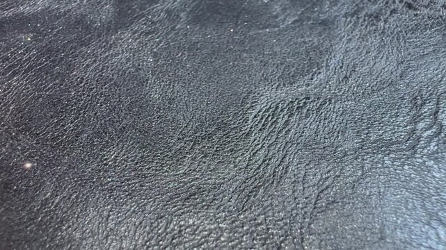 Macro Close Up of Shimmering Leather Texture Background. Close Up Glitter Leather Texture Background with Shimmering Surface
Macro view of glitter leather texture with a subtle shimmering surface. 